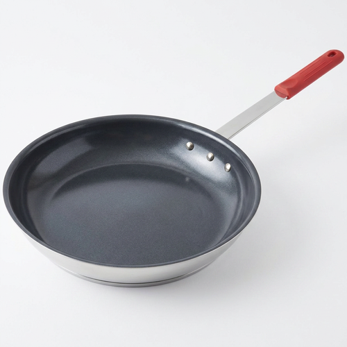 Red ceramic nonstick egg pan on white background