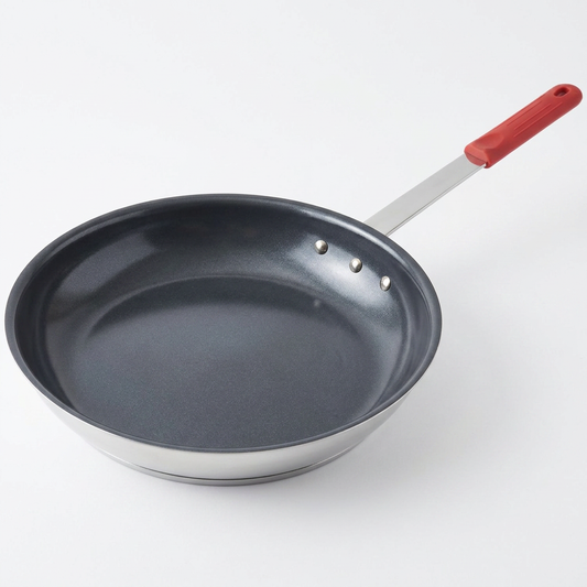 Red ceramic nonstick egg pan on white background