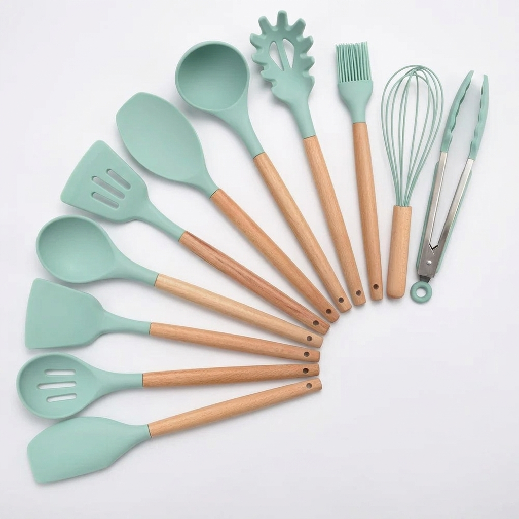 Light green 11-piece silicone utensil set on white background